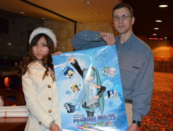 Yuki Dong with autographed poster promoting Hatsune Miku Project Diva Arcade Song Collection 2 CD with her song.